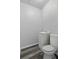 Compact half bathroom featuring modern toilet, vanity, and flooring at 7214 Oakwood Dr, New Port Richey, FL 34652