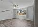 Bright bedroom with wood floors, a ceiling fan, and a large window offering natural light at 7214 Oakwood Dr, New Port Richey, FL 34652
