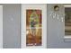 Attractive front door with decorative glass and house number, complemented by a stylish exterior light fixture at 7214 Oakwood Dr, New Port Richey, FL 34652