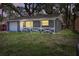 Beautiful single-story home with a covered porch and a one car garage at dusk at 7214 Oakwood Dr, New Port Richey, FL 34652