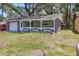 Inviting home with fresh exterior paint, white trim, fenced lawn, and attached garage at 7214 Oakwood Dr, New Port Richey, FL 34652