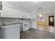 Modern kitchen with white cabinets, granite countertops, stainless steel appliances and wood floors at 7214 Oakwood Dr, New Port Richey, FL 34652