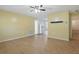 Bright living room featuring wood-look flooring, a ceiling fan, and connecting entryways to other rooms at 7214 Oakwood Dr, New Port Richey, FL 34652