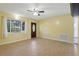 Spacious living room boasts wood-look floors, a decorative front door, and plenty of natural light at 7214 Oakwood Dr, New Port Richey, FL 34652