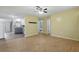 Inviting living room with wood-look floors, ceiling fan, open layout to kitchen with stainless appliances at 7214 Oakwood Dr, New Port Richey, FL 34652