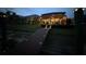 Backyard deck and dock at night with bistro lights and pathway lights for evening enjoyment at 18018 Malakai Isle Dr, Tampa, FL 33647
