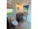 Bright bathroom features a unique vanity, round mirror, and a window for natural light at 18018 Malakai Isle Dr, Tampa, FL 33647