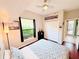 Well-lit bedroom with a ceiling fan, closet, and modern decor overlooking backyard at 18018 Malakai Isle Dr, Tampa, FL 33647