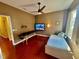 Relaxing bedroom featuring a massage table, TV, and a comfortable bed, perfect for unwinding at 18018 Malakai Isle Dr, Tampa, FL 33647