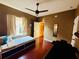 Cozy bedroom featuring a massage table, window, hardwood floors and closet at 18018 Malakai Isle Dr, Tampa, FL 33647