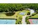 Aerial view of various community courts including tennis, basketball, and a green space, all surrounded by trees at 18018 Malakai Isle Dr, Tampa, FL 33647