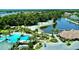 Inviting community pool area featuring a beach, sun loungers, and lush landscaping at 18018 Malakai Isle Dr, Tampa, FL 33647