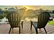 Scenic view of deck with chairs overlooking serene lake at sunset, perfect for relaxation at 18018 Malakai Isle Dr, Tampa, FL 33647