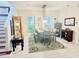 Bright dining room with stylish rug, modern light fixture, and large windows with lush green views at 18018 Malakai Isle Dr, Tampa, FL 33647