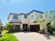 Beautiful two-story home featuring a three car garage and professionally landscaped yard at 18018 Malakai Isle Dr, Tampa, FL 33647