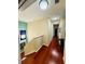 Bright upstairs hallway with hardwood floors leading to bedrooms and other living spaces at 18018 Malakai Isle Dr, Tampa, FL 33647