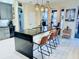 Modern kitchen with stainless steel appliances, granite countertops, and bar seating at 18018 Malakai Isle Dr, Tampa, FL 33647