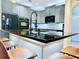 Stylish kitchen island with bar seating, granite countertops, and modern lighting at 18018 Malakai Isle Dr, Tampa, FL 33647