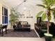 Cozy living room with leather furniture, decorative plants and modern decor at 18018 Malakai Isle Dr, Tampa, FL 33647
