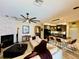 Open concept living area with fireplace, kitchen island and views of the backyard at 18018 Malakai Isle Dr, Tampa, FL 33647