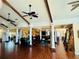 Spacious lounge area with elegant furnishings, wood floors, and decorative pillars at 18018 Malakai Isle Dr, Tampa, FL 33647