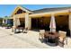 Outdoor patio area with cozy seating arrangement, umbrellas, and plenty of shade at 18018 Malakai Isle Dr, Tampa, FL 33647