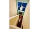 Overhead view of a bright stairway with hardwood steps and decorative ceiling fixture at 18018 Malakai Isle Dr, Tampa, FL 33647