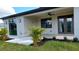 Back porch area with ceiling fan, lighting fixtures, and manicured garden at 3269 Ponce De Leon Blvd, North Port, FL 34291