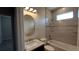 Bathroom featuring tiled walls, an octagonal mirror, vanity with sink, toilet, and bathtub with shower at 3269 Ponce De Leon Blvd, North Port, FL 34291
