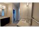 Modern bathroom featuring double vanities, mirrors, and a view into the toilet and bathtub area at 3269 Ponce De Leon Blvd, North Port, FL 34291