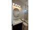 Bathroom featuring tiled walls, an octagonal mirror, vanity with sink, toilet, and bathtub with shower at 3269 Ponce De Leon Blvd, North Port, FL 34291