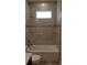 Bathroom featuring tiled walls, shower head, and a small window providing natural lighting at 3269 Ponce De Leon Blvd, North Port, FL 34291