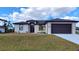 Charming single-story home with a two-car garage, manicured lawn, and a beautifully landscaped yard at 3269 Ponce De Leon Blvd, North Port, FL 34291