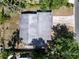 Aerial view of the home's roof, surrounded by mature trees and landscaping at 404 Courtney Dr, Temple Terrace, FL 33617