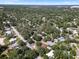 An aerial view of the neighborhood featuring mature trees and well-maintained homes at 404 Courtney Dr, Temple Terrace, FL 33617
