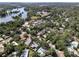 Community aerial view showcasing lush greenery and a nearby lake at 404 Courtney Dr, Temple Terrace, FL 33617