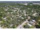 Aerial view showcasing community and street layout surrounded by mature trees at 404 Courtney Dr, Temple Terrace, FL 33617
