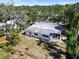 Aerial view of fenced backyard, including screened in porch and mature trees at 404 Courtney Dr, Temple Terrace, FL 33617