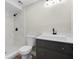 Modern bathroom with white tiled shower and a gray vanity featuring a vessel sink at 404 Courtney Dr, Temple Terrace, FL 33617