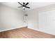 Bedroom with hardwood floors, neutral paint, ceiling fan, and a double door closet at 404 Courtney Dr, Temple Terrace, FL 33617