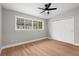 Bedroom featuring hardwood floors, a ceiling fan, and a large window at 404 Courtney Dr, Temple Terrace, FL 33617