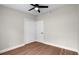 A quaint bedroom with hardwood floors, neutral paint, ceiling fan, and a closet at 404 Courtney Dr, Temple Terrace, FL 33617
