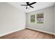 Bedroom with hardwood floors, neutral walls, ceiling fan and a large window at 404 Courtney Dr, Temple Terrace, FL 33617