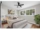 Staged bedroom featuring warm accents, modern art, and a large window at 404 Courtney Dr, Temple Terrace, FL 33617