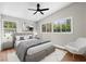 Modern bedroom with stylish furniture, hardwood floors, ceiling fan and lots of natural light at 404 Courtney Dr, Temple Terrace, FL 33617