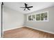 Bright bedroom featuring wood floors, a ceiling fan, and a large window at 404 Courtney Dr, Temple Terrace, FL 33617