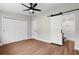 Bedroom featuring hardwood floors and a sliding barn door to the bathroom at 404 Courtney Dr, Temple Terrace, FL 33617