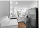 Well-lit kitchen with modern appliances, white cabinets, and quartz countertops at 404 Courtney Dr, Temple Terrace, FL 33617