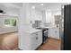 Updated kitchen featuring stainless steel appliances, white cabinets, and new countertops at 404 Courtney Dr, Temple Terrace, FL 33617