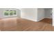 Refinished living room with hardwood floors, neutral paint, and large windows at 404 Courtney Dr, Temple Terrace, FL 33617